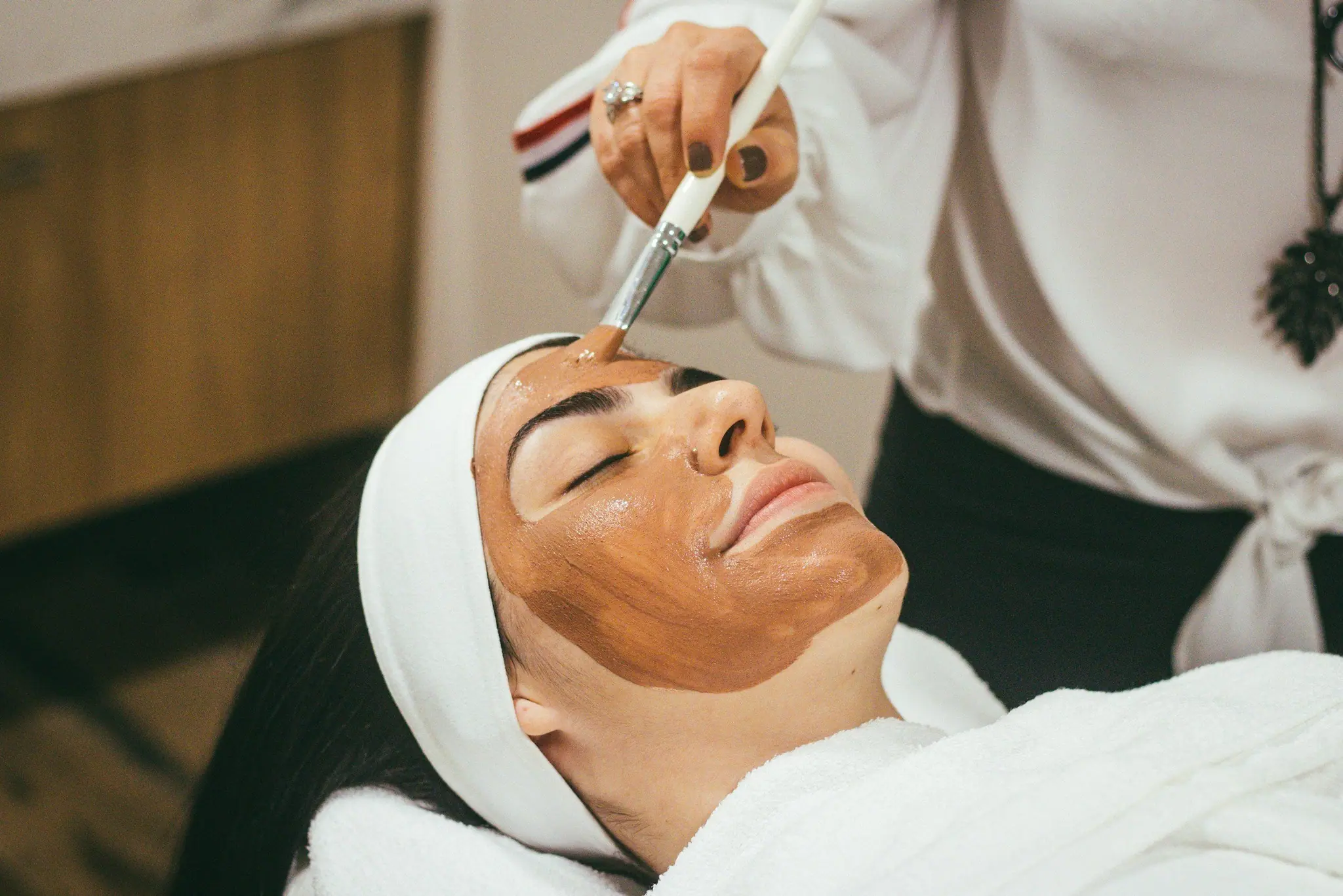 A chemical peel being applied with a brush during a facial