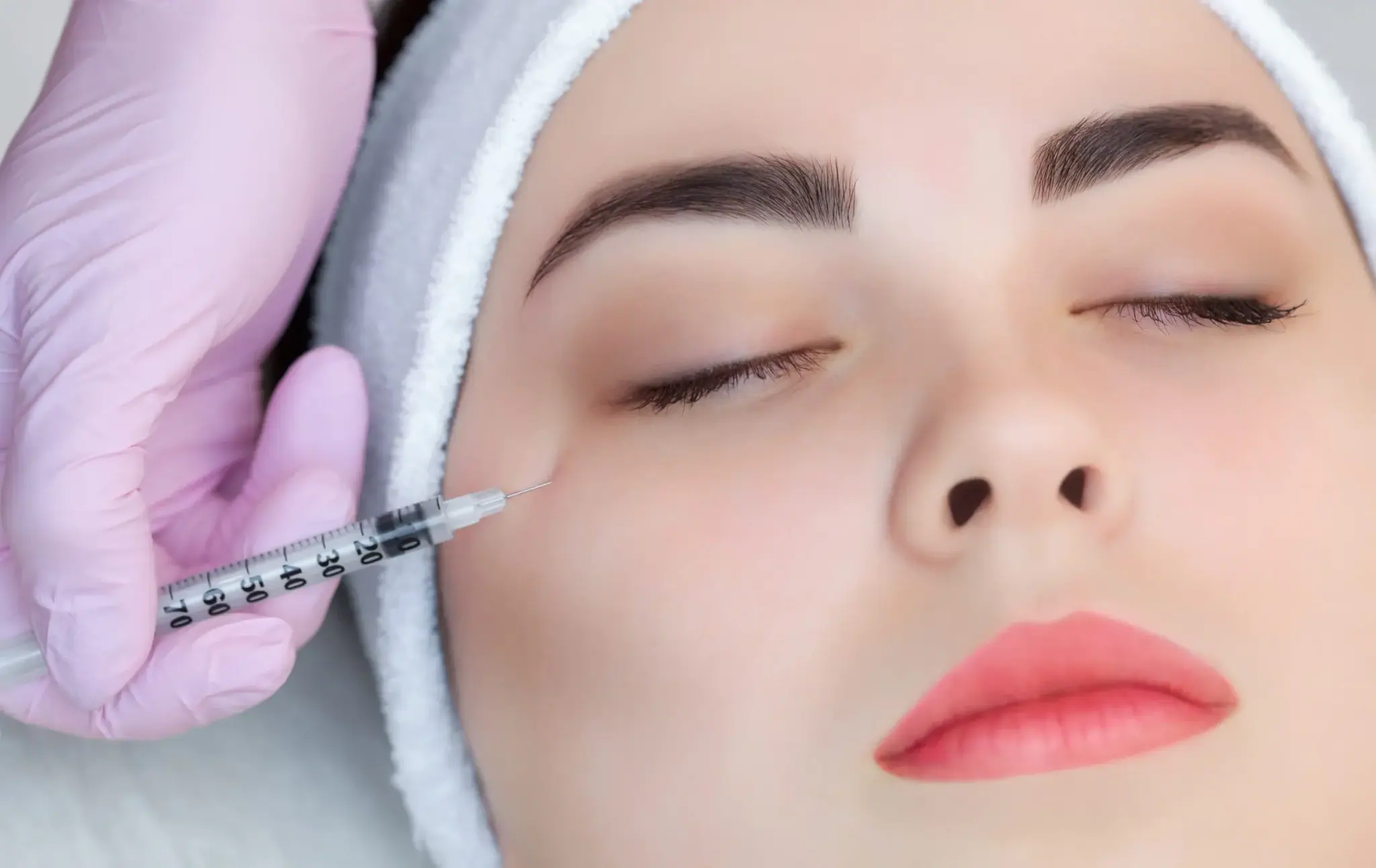 A client relaxing during a gentle injectable treatment